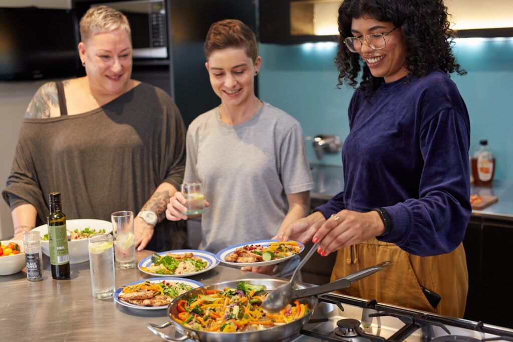 Three South African friends with diabetes serving healthy food for lunch