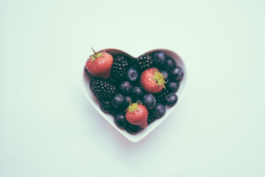 heart-shaped bowl with strawberries